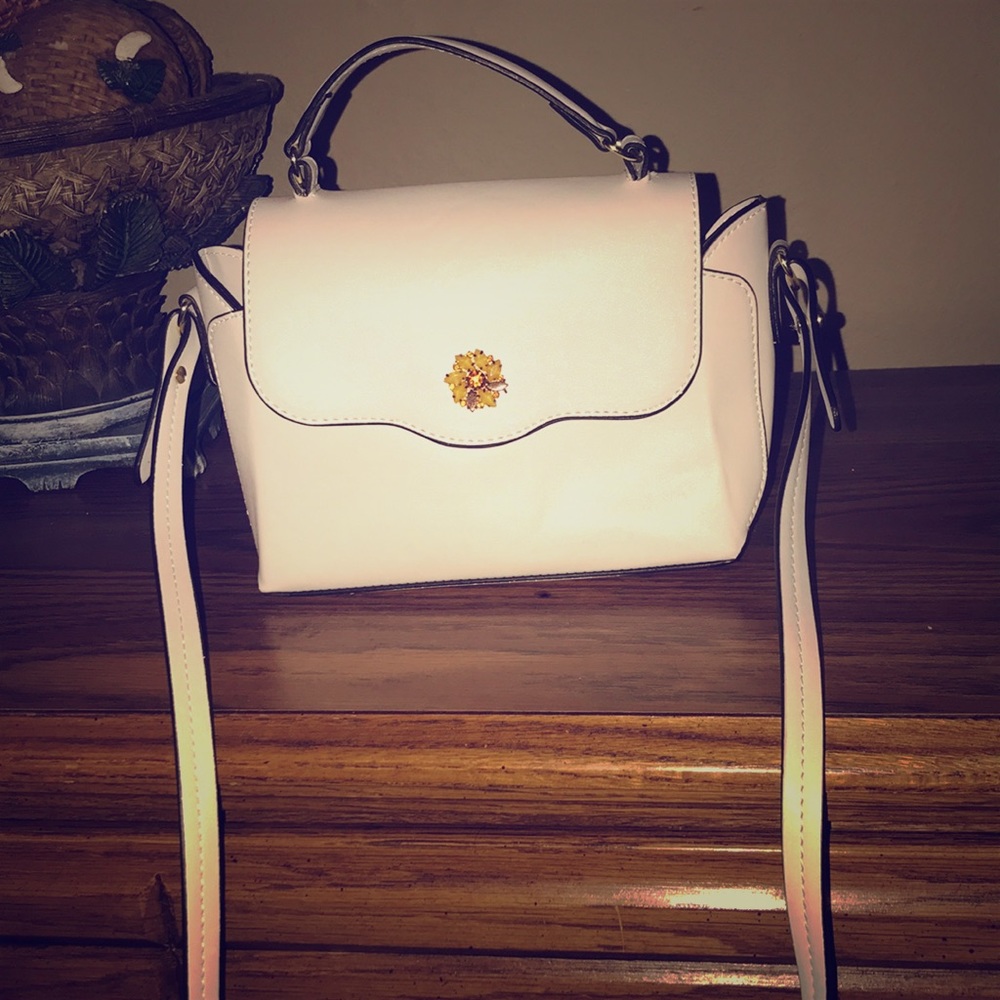 White purse with small yellow flower